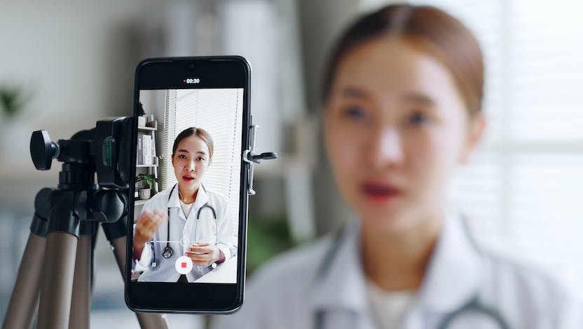 Physician recording video on smartphone