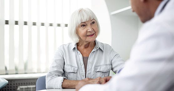 Image of senior patient talking to her geriatrician