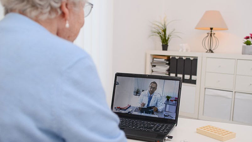 Older woman talking with her doctor on a computer screen