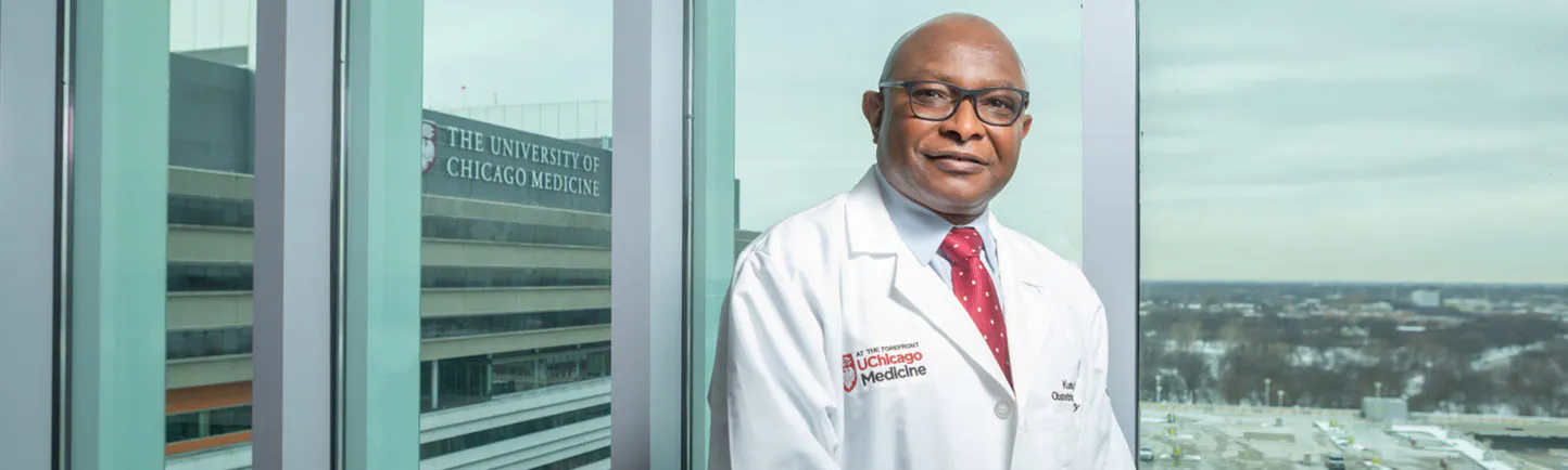 Kunle Odunsi, MD, Director of the Comprehensive Cancer Center, with a view of the Center for Care and Discovery in the background.