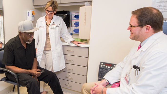 Joan Bigane, RN, elderly male patient and James Wallace, MD, in geriatric oncology clinic