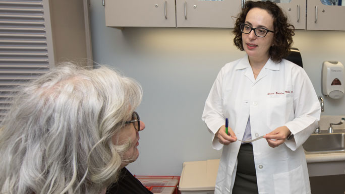 Drs. Diana Bolotin and Eduardo Moioli with a patient in clinic