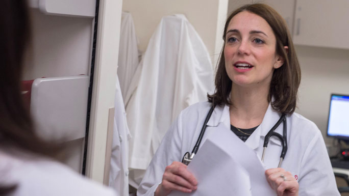 Jane Churpek, MD, in clinic, talking to colleague