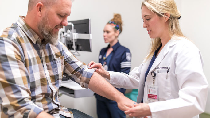 Ashley Feneran, DO, with a patient at the South Loop location
