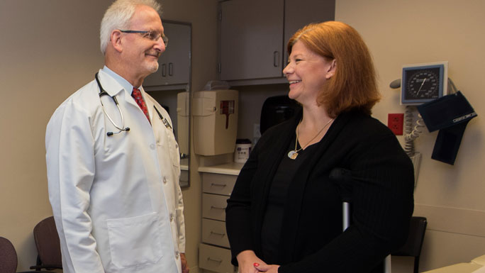 Mark Ferguson, MD, thoracic surgeon, in clinic with patient