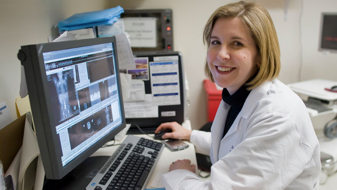 Tara Henderson, MD, MPH, working at a computer