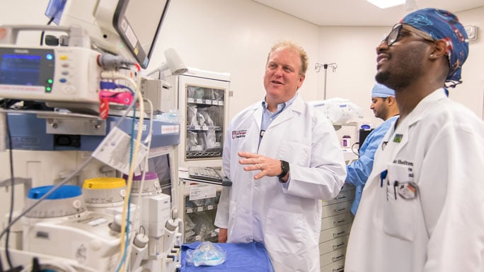 D. Kyle Hogarth, MD, in the bronchoscopy lab with a colleague
