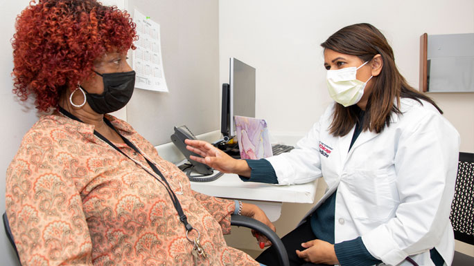 medical oncologist Ardaman Shergill, MD, and patient in clinic