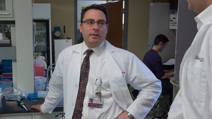 Russell Szmulewitz, MD, in lab