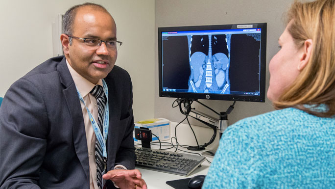 Kiran Turaga, MD, with patient in clinic