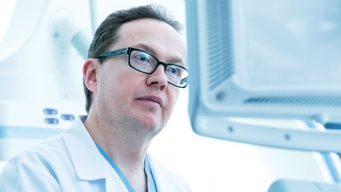 Irving Waxman, MD, interventional endoscopy, looking at digital monitor