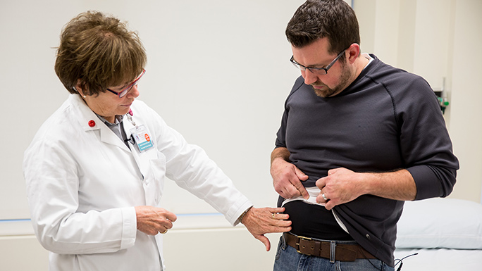 Janice Colwell, RN, MS, CWOCN, FAAN, ostomy nurse specialist with a patient