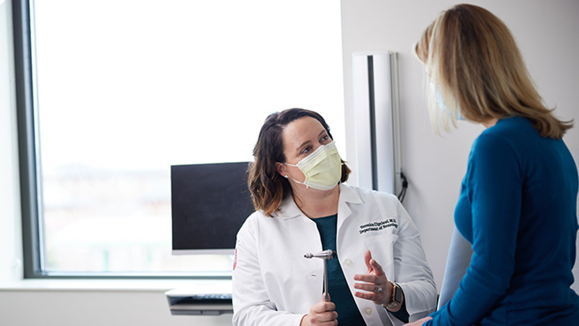 Dr. Cipriani talking with a female patient in an exam room