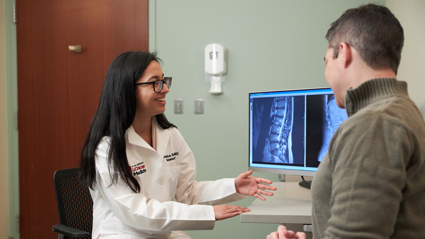 Paramita Das, MD with a patient in hospital room