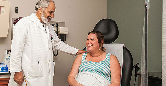 Maternal-fetal medicine expert Mahmoud Ismail, MD, consults with a patient