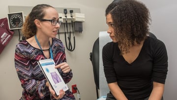 Amber Truehart, MD, and female teen in clinic