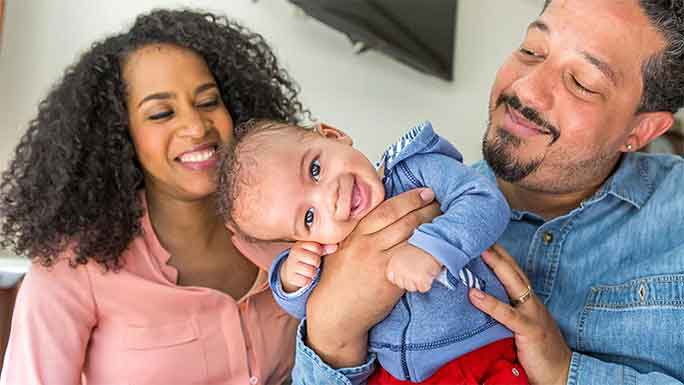 Smiling parents and baby