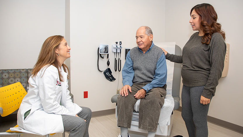 Mary Rinella, MD, with a latino patient and his daughter