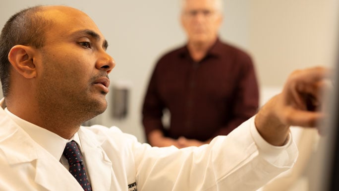 Head and neck surgeon Nishant Agrawal, MD, explaining a scan to a patient