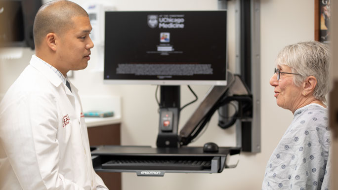 Oliver Eng, MD, in DCAM clinic with patient