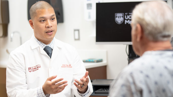 Oliver Eng, MD, meets with a patient in clinic