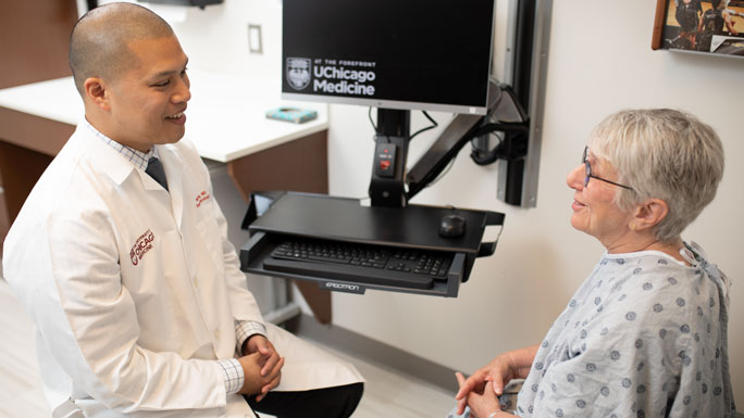 Oliver Eng, MD, meets with a patient in clinic
