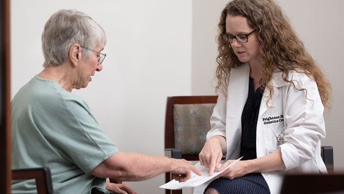 Feighanne Hathaway, genetic counselor, meets with patient in DCAM