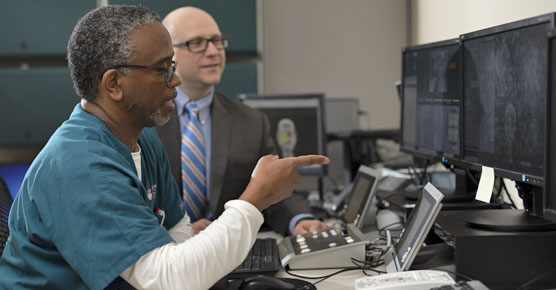Radiation oncologist Michael Spiotto, MD, and staff member