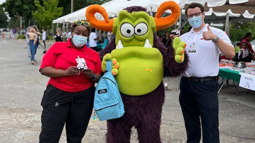 Image of Remoc and volunteers at a safety fair