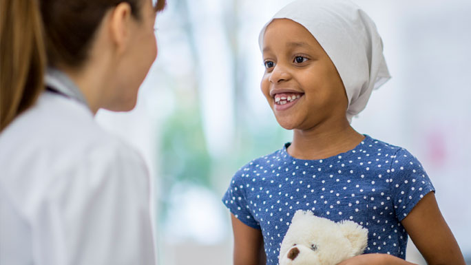 Young girl with cancer, in headscarf
