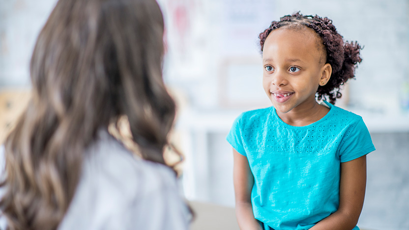Image of pediatric doctor talking to child about neutropenia
