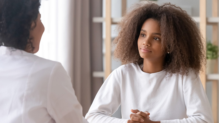 Image of pediatric patient talking to a doctor about pediatric fertility preservation