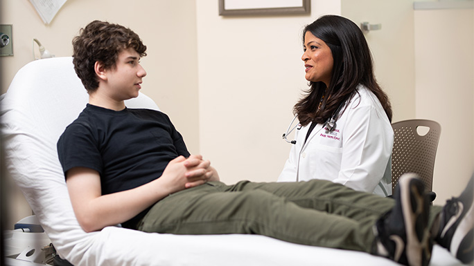 Dr. Ami Desai working with pediatric cancer patient