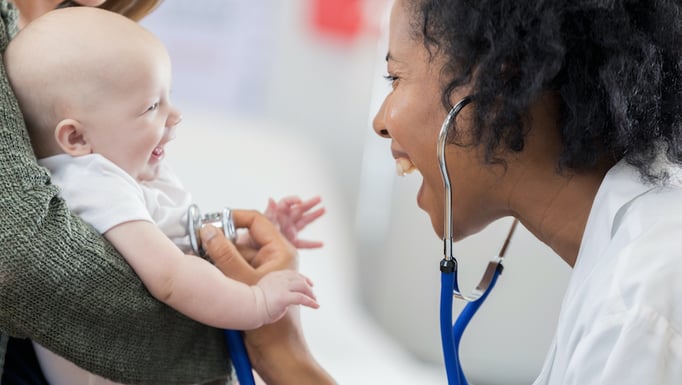 smiling baby and doctor