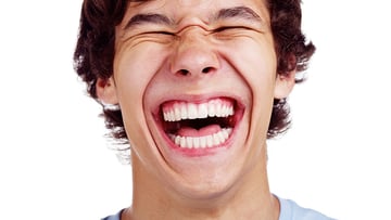 A teenager with a large smile.