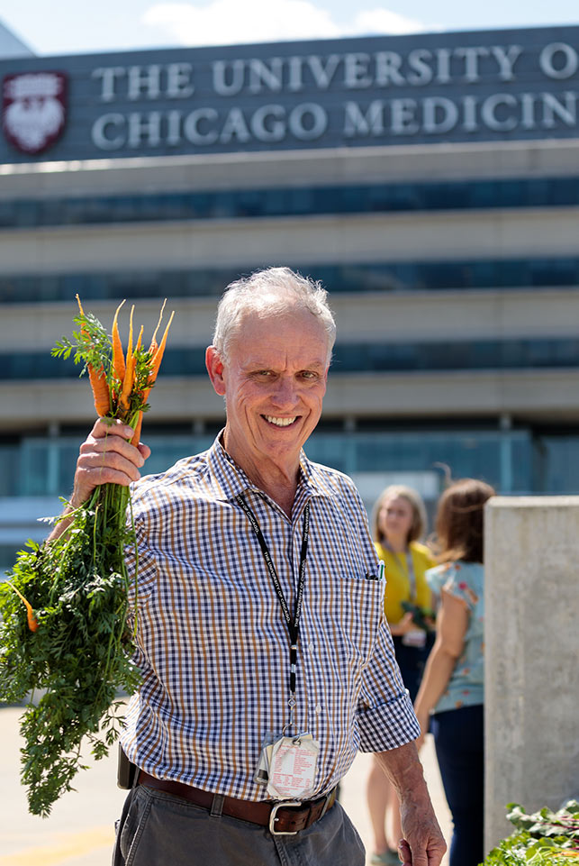 Holding carrots in the veggie garden