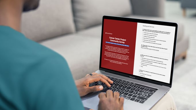 man filling out Cancer Center Project Survey on laptop