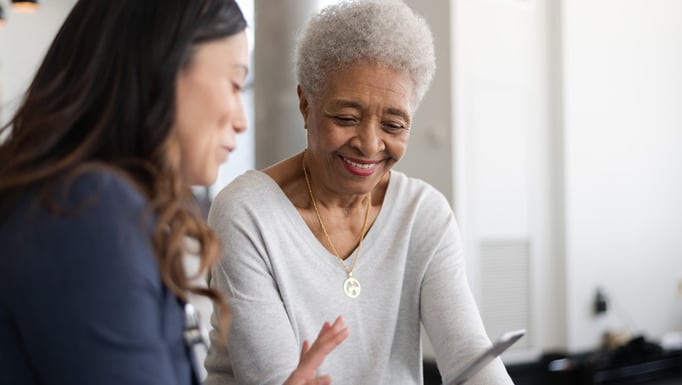 younger woman showing cell phone to older woman