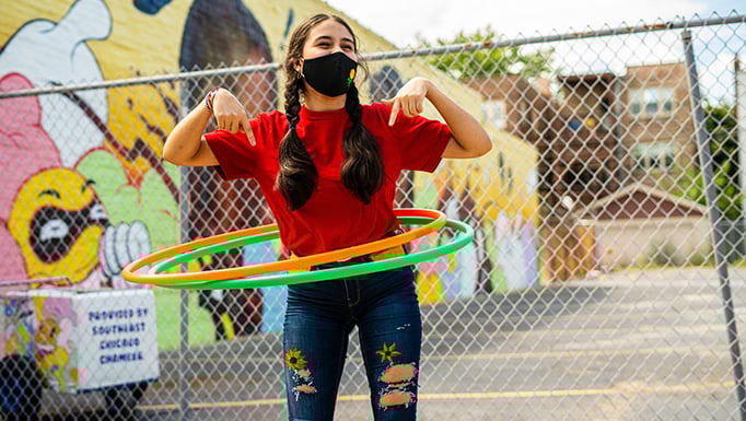 Masked girl hula hooping