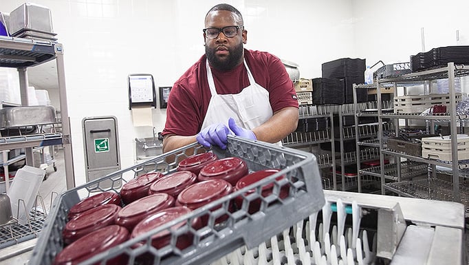 Employee washing dishes