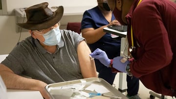 A patient is prepared by UChicago Medicine staff to receive a COVID-19 vaccine.