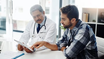 Male doctor and patient having a discussion in the doctor