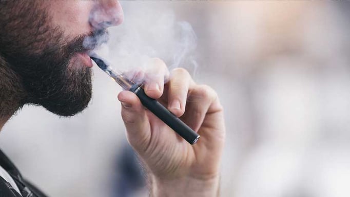 Man using vaping pipe