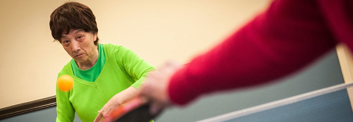 Cheng Xiu Xu playing ping pong after undergoing DBS to help control Parkinson