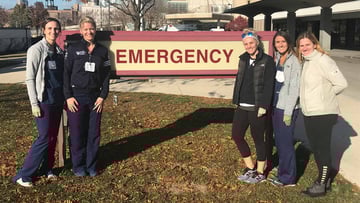 University of Chicago Medicine nurses take a picture outside an emergency room sign at Mercy Hospital & Medical Center.