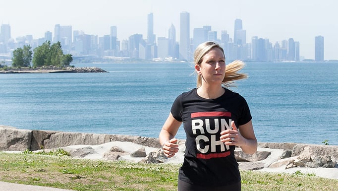 Woman running along the lakeshore path