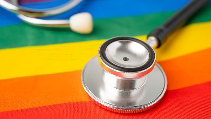 Black stethoscope on rainbow flag background
