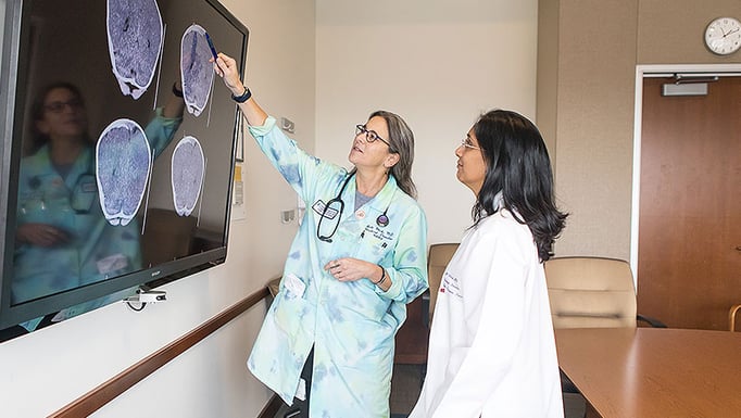 Child abuse pediatricians Drs. Jill Glick and Veena Ramaiah reviewing scans