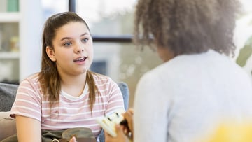 A teen talking with a transition clinic provider