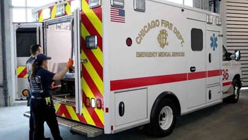 An EMS crew in an ambulance unloads at patient at UChicago Medicine